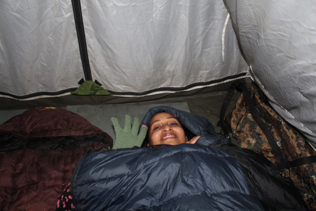 MJ inside the sleeping bag in the base camp of Nag Tibba Trek